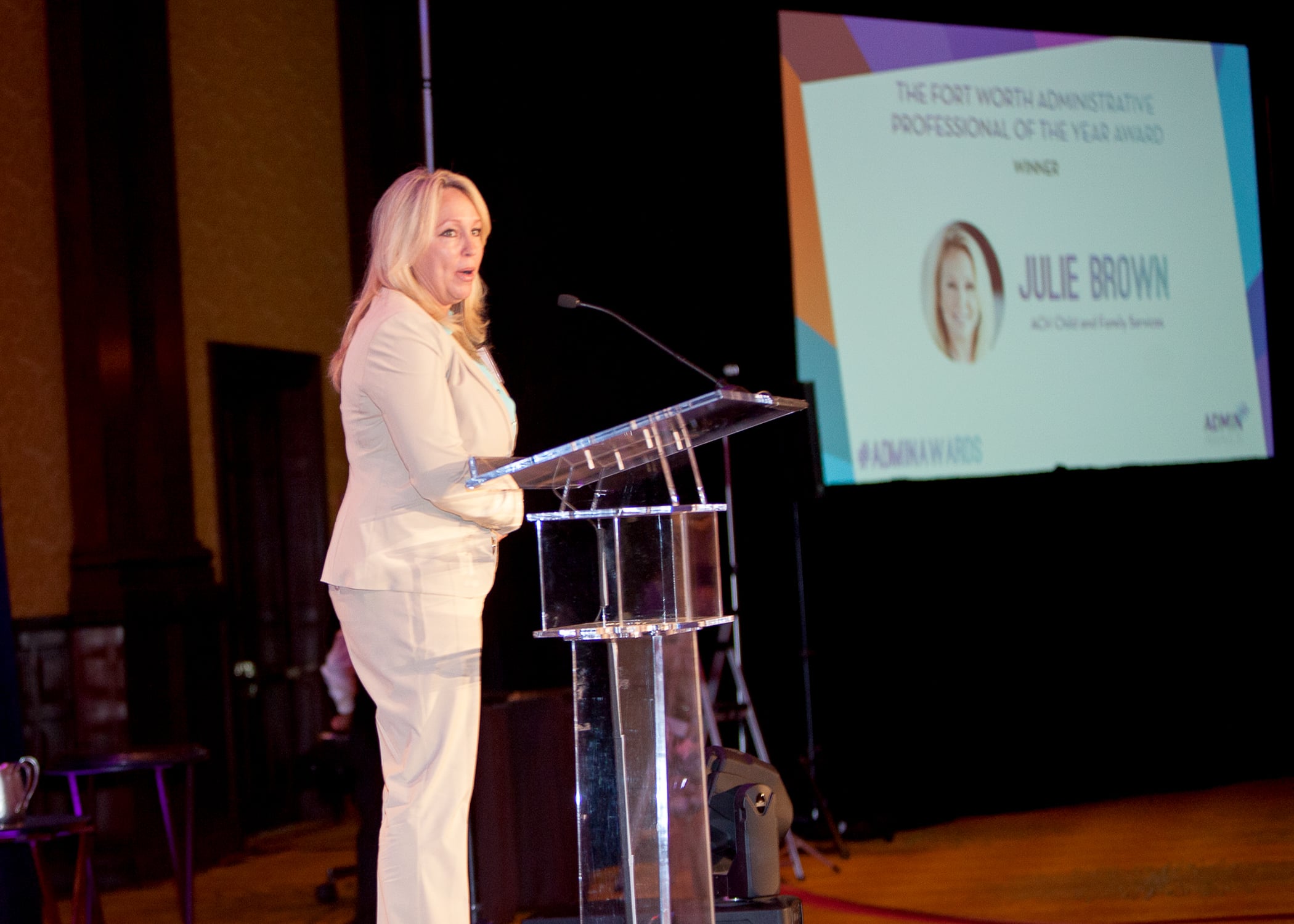 A speaker on stage at the Admin Awards Gala in Fort Worth